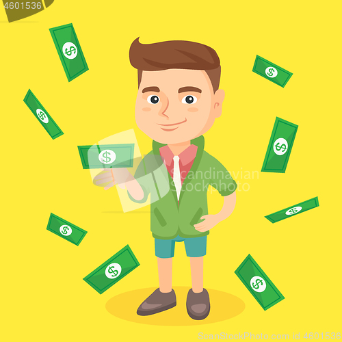 Image of Little caucasian boy standing under money rain.