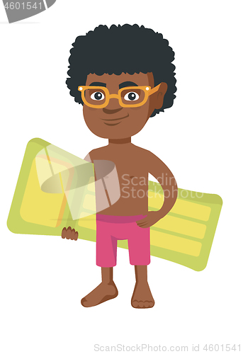 Image of Little african boy holding inflatable mattress.