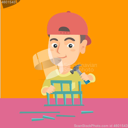 Image of Boy playing with toy constructor and hammer.