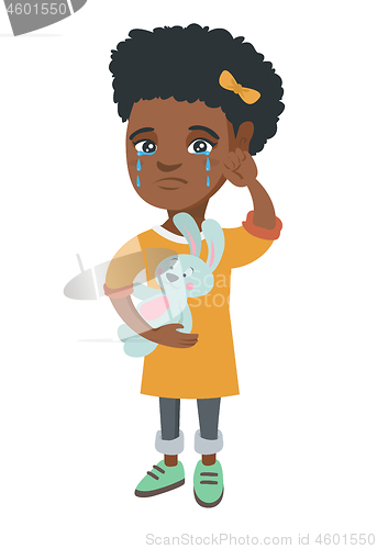 Image of African-american girl crying and holding toy.