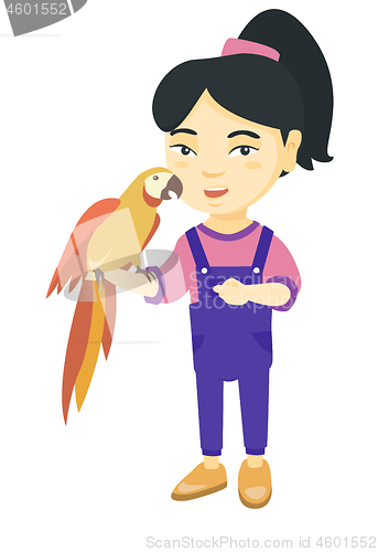 Image of Asian little girl holding parrot on her hand.