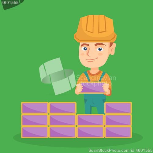 Image of Caucasian bricklayer boy building a brick wall.