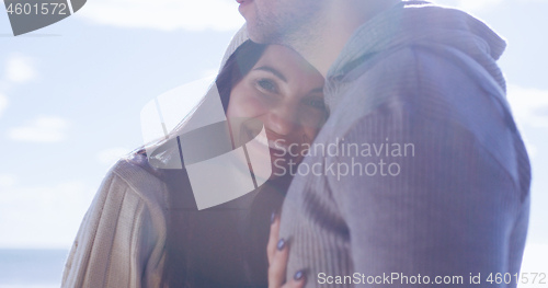 Image of Couple having fun on beautiful autumn day at beach