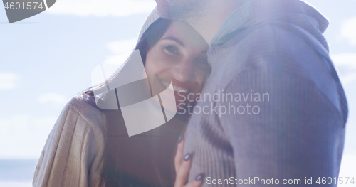 Image of Couple having fun on beautiful autumn day at beach