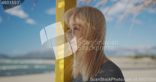 Image of Young woman enjoying the warm autumn day