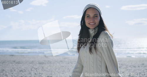 Image of Girl In Autumn Clothes Smiling on beach