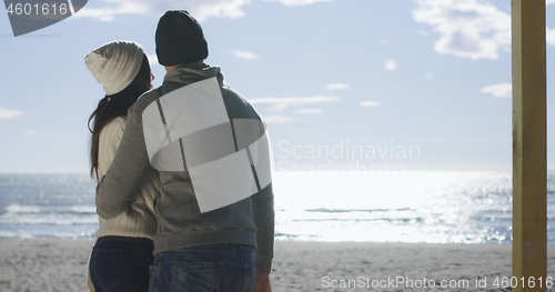 Image of Couple having fun on beautiful autumn day at beach