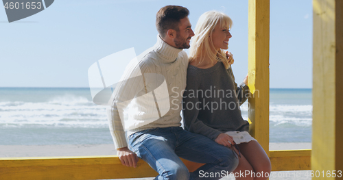 Image of Couple chating and having fun at beach bar