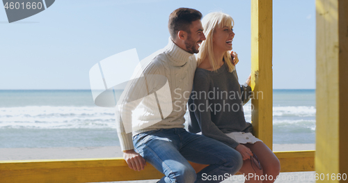 Image of Couple chating and having fun at beach bar