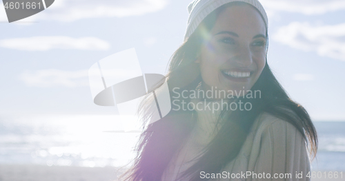 Image of Girl In Autumn Clothes Smiling on beach