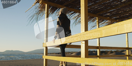 Image of Young woman enjoying the warm autumn day