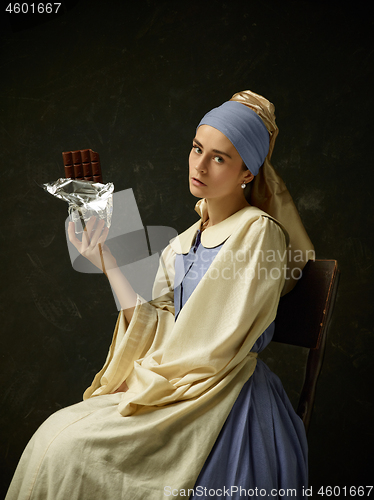 Image of Medieval Woman in Historical Costume Wearing Corset Dress and Bonnet.