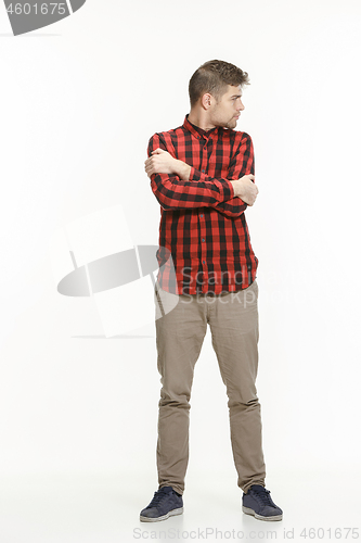 Image of Serious business man standing on white studio background