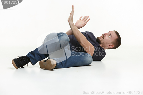 Image of young cool man full body scared pose.