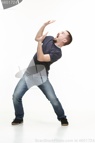 Image of young cool man full body scared pose.