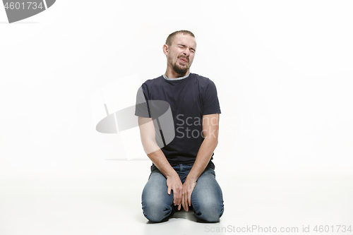 Image of very disappointed man isolated on white background. studio shot