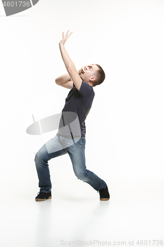 Image of young cool man full body scared pose.