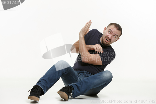 Image of young cool man full body scared pose.