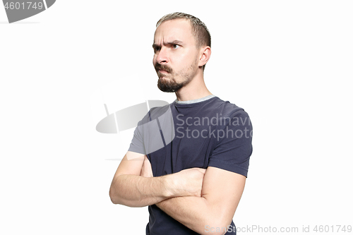 Image of Serious business man standing on white studio background