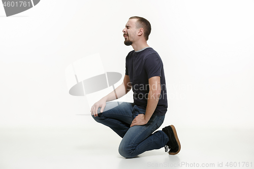 Image of very disappointed man isolated on white background. studio shot