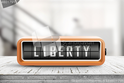 Image of Liberty message on an orange alarm clock