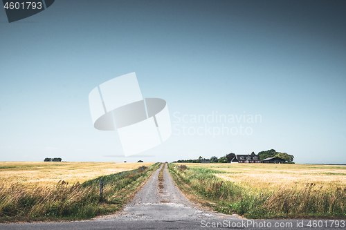 Image of Rural scenery with a road passing a small farm