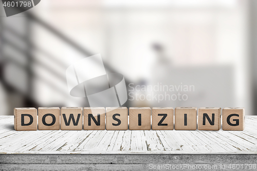 Image of Downsizing message sign made of wood