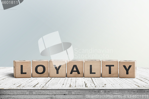 Image of Loyalty sign on a wooden table in bright daylight