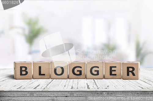 Image of Blogger sign in a bright living room with green plants