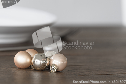 Image of Christmas baubles in elegant colors on a dinner table