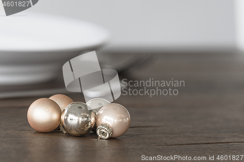 Image of Christmas baubles in elegant colors on a dinner table