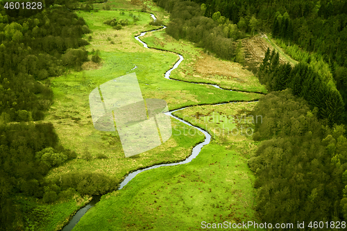 Image of Curvy river running through a green area