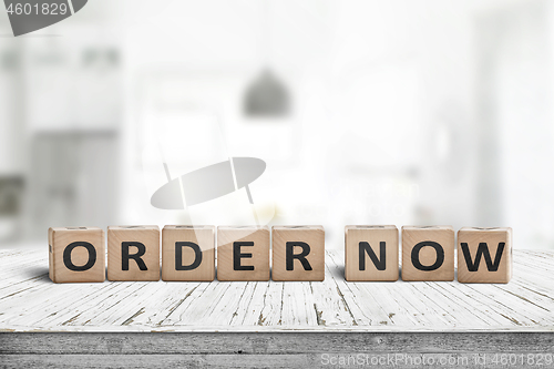 Image of Order now sign on a wooden table