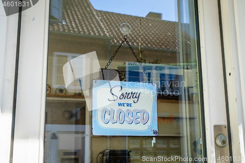 Image of Closed sign hanging in a store window