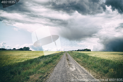 Image of Rural landscape with dark clouds over a countyside