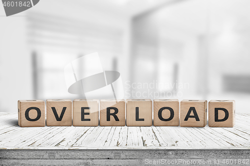 Image of Sign with the word overload in a bright office