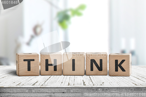 Image of Think message sign on a worn table