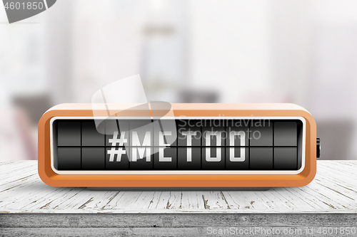 Image of Metoo hashtag message on a retro alarm device