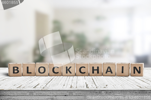 Image of Blockchain sign made of wood on a desk