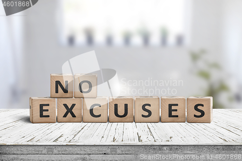 Image of No excuses sign in a bright room