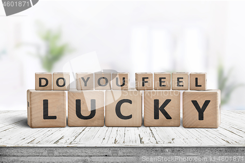 Image of Do you feel lucky sign on a wooden table