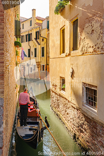 Image of Venice, Italy. Tourists riding gondolas