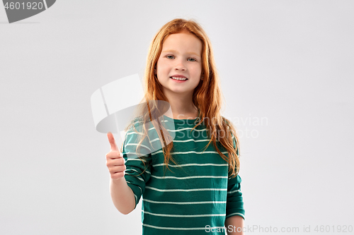 Image of smiling red haired girl showing thumbs up