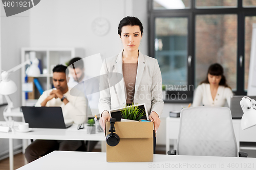 Image of female office worker with box of personal stuff