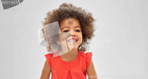 Image of happy little african american girl over grey