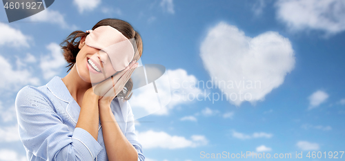 Image of happy young woman in pajama and eye sleeping mask