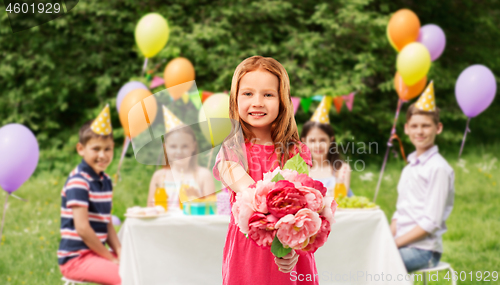 Image of red haired girl with flowers at birthday party