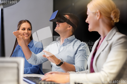 Image of business team with computer working late at office