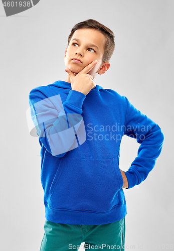 Image of thinking boy in blue hoodie