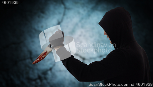 Image of close up of criminal with blood on knife